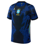Brazil Away Football Shirt 2026 Jordan Brand dark navy black showing royal blue vertical pinstripe shadow silhouette graphic pattern CBF Brazil Football Federation blue shield crest 5 gold stars BRASIL yellow text yellow Jordan Jumpman logo teal mint green side panel yellow seam accents black crew neck front side angle view on white background
