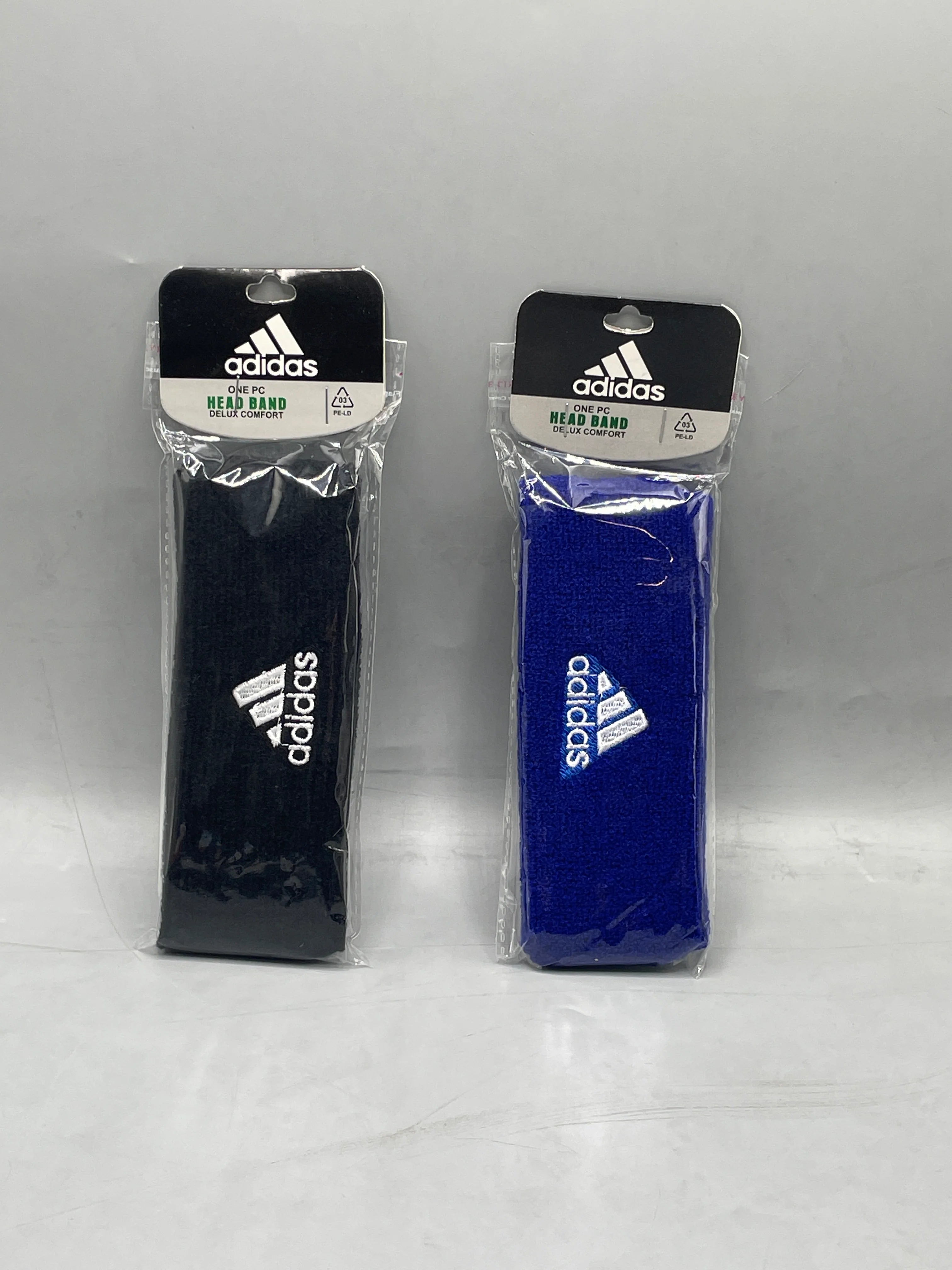 Adidas Delux Comfort sports headband black and blue in individual retail packaging - front view