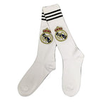 Real Madrid FC Football Socks white knee high showing 3 black stripes top cuff and Real Madrid FC gold crown woven club crest with royal blue gold shield Real Madrid CF monogram on shin pair view on white background