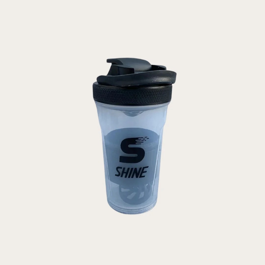 SHINE Protein Shaker Bottle black transparent body with black flip-lock lid showing SHINE S logo branding - front view single bottle