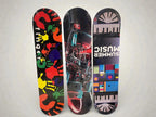 Three graphic skateboards showing Finger handprint, F1 Mercedes and Summer Music designs - front view