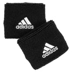 Adidas Delux Comfort wrist band close-up showing embroidered Adidas logo on black terry cotton