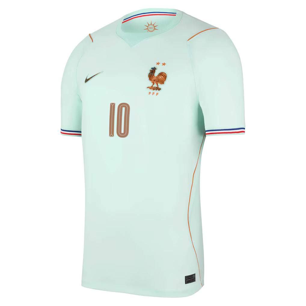 France Away Football Shirt 2026 Nike mint ice green showing FFF bronze Gallic Rooster crest with 2 gold stars Nike swoosh number 10 in bronze on chest orange seam side accent blue red orange cuff trim crew neck front side angle view on white background
