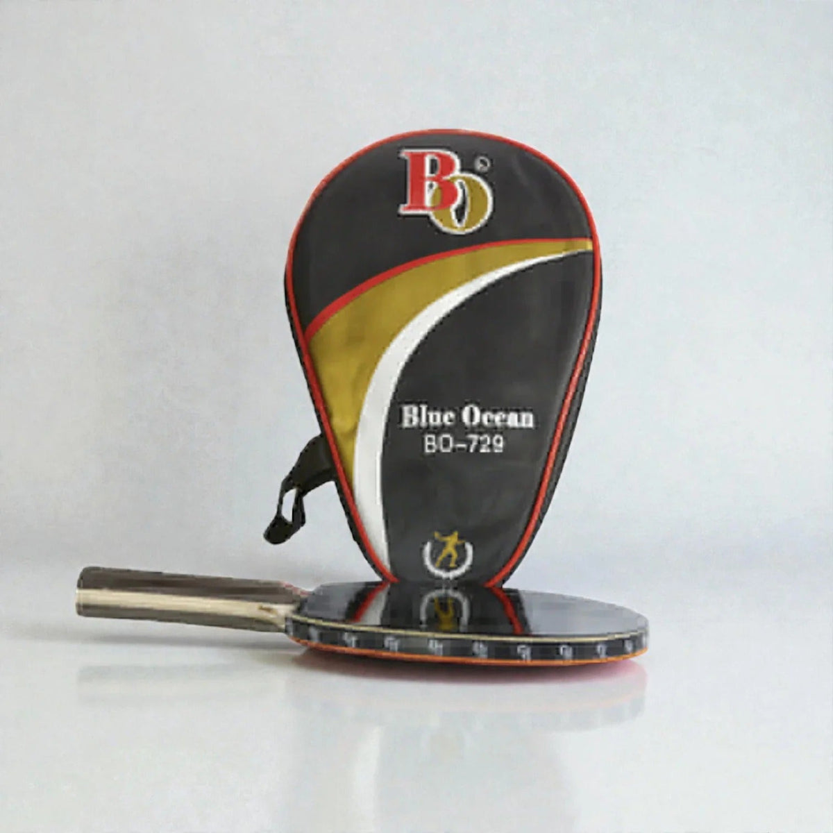 Blue Ocean BO-729 Table Tennis Racket lying flat beside black gold red white BO-729 racket shaped carry case on grey background - flat lay view