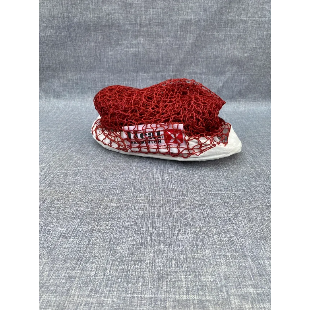 Heat X badminton net iron wire H-16 red nylon mesh folded showing Heat X Badminton branding on white tape band