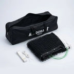 Adoral lawn tennis net double complete set showing folded black net, center strap and open black Adoral Tennis carry bag - side view