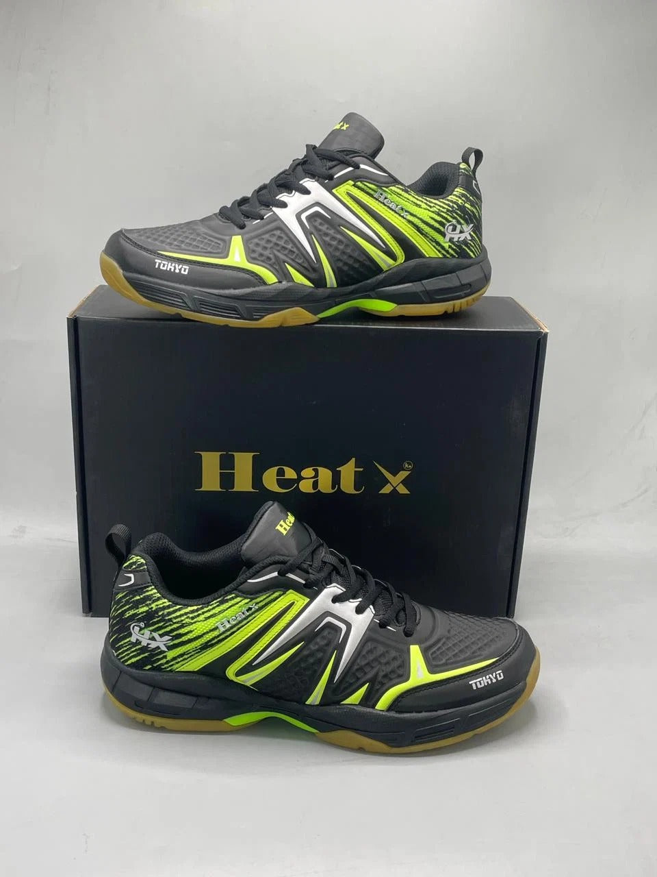 Heat X Tokyo badminton shoes lime green blue pair showing hexagonal rubber outsole and side profile