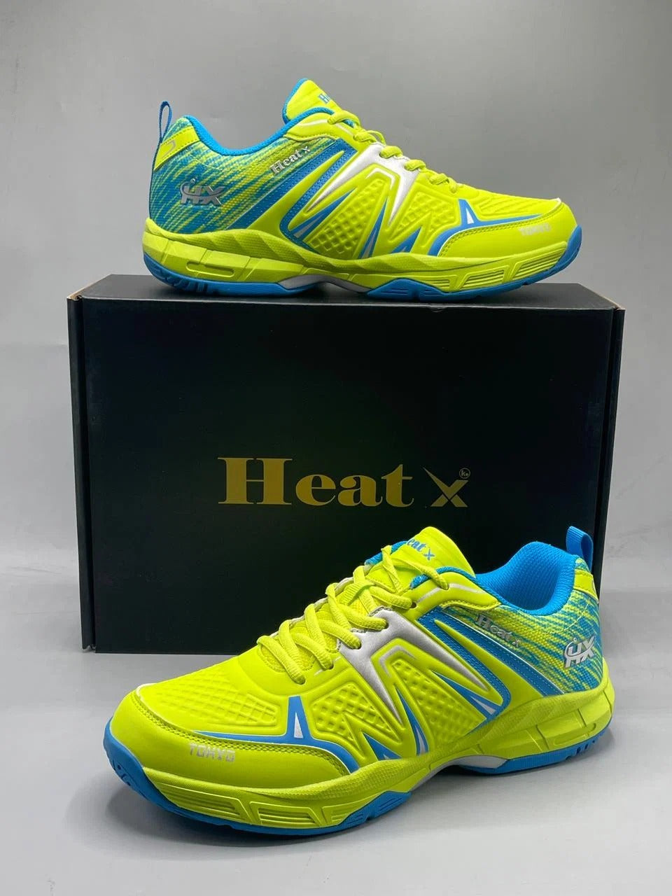 Heat X Tokyo badminton shoes lime green blue pair side view showing Tokyo branding and non-slip hexagonal sole