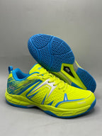Heat X Tokyo badminton shoes yellow black pair showing hexagonal rubber outsole and side profile