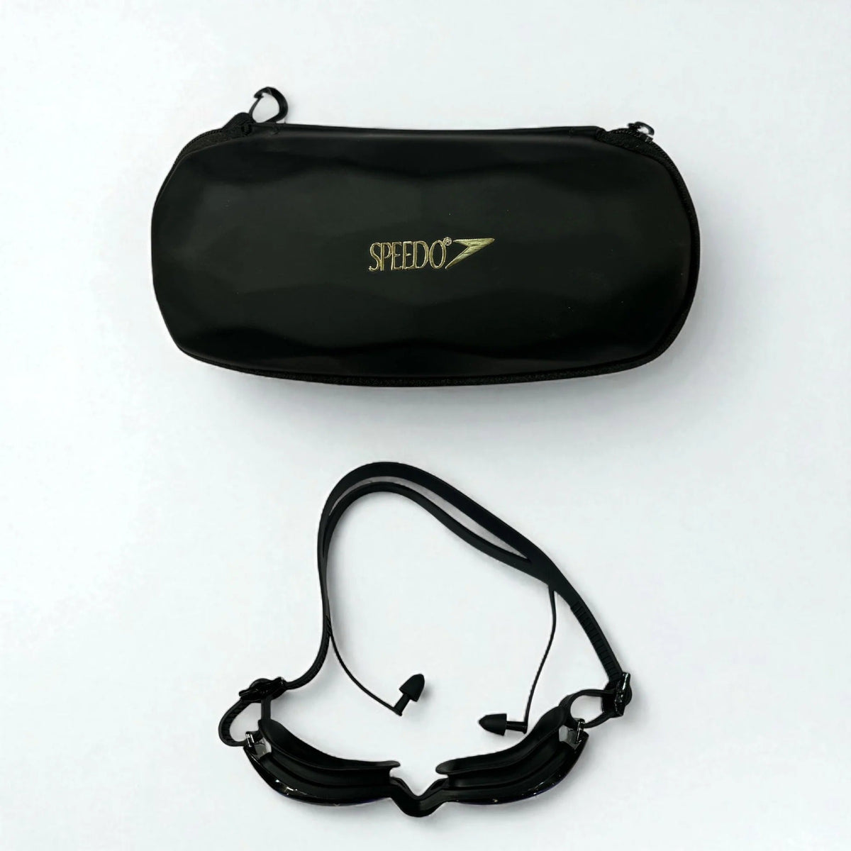 Speedo black competition swimming goggles with ear plugs and hard case - complete set flat lay
