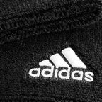 Adidas Delux Comfort sports wrist band black pair flat lay showing embroidered Adidas three-stripe logo