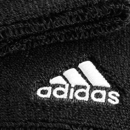 Adidas Delux Comfort sports wrist band black pair flat lay showing embroidered Adidas three-stripe logo