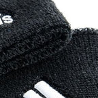 Adidas Delux Comfort wrist band close-up showing thick terry cotton texture and three-stripe branding