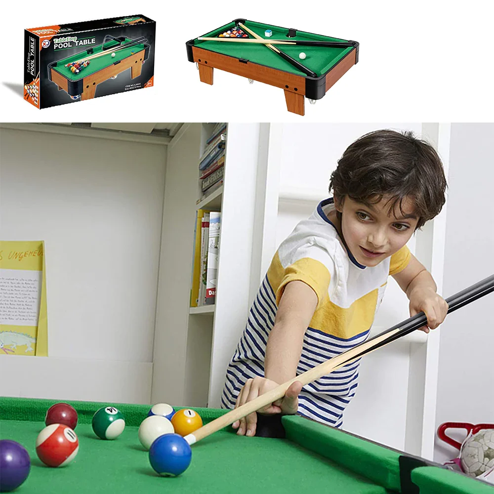 Kid playing with tabletop pool table at home